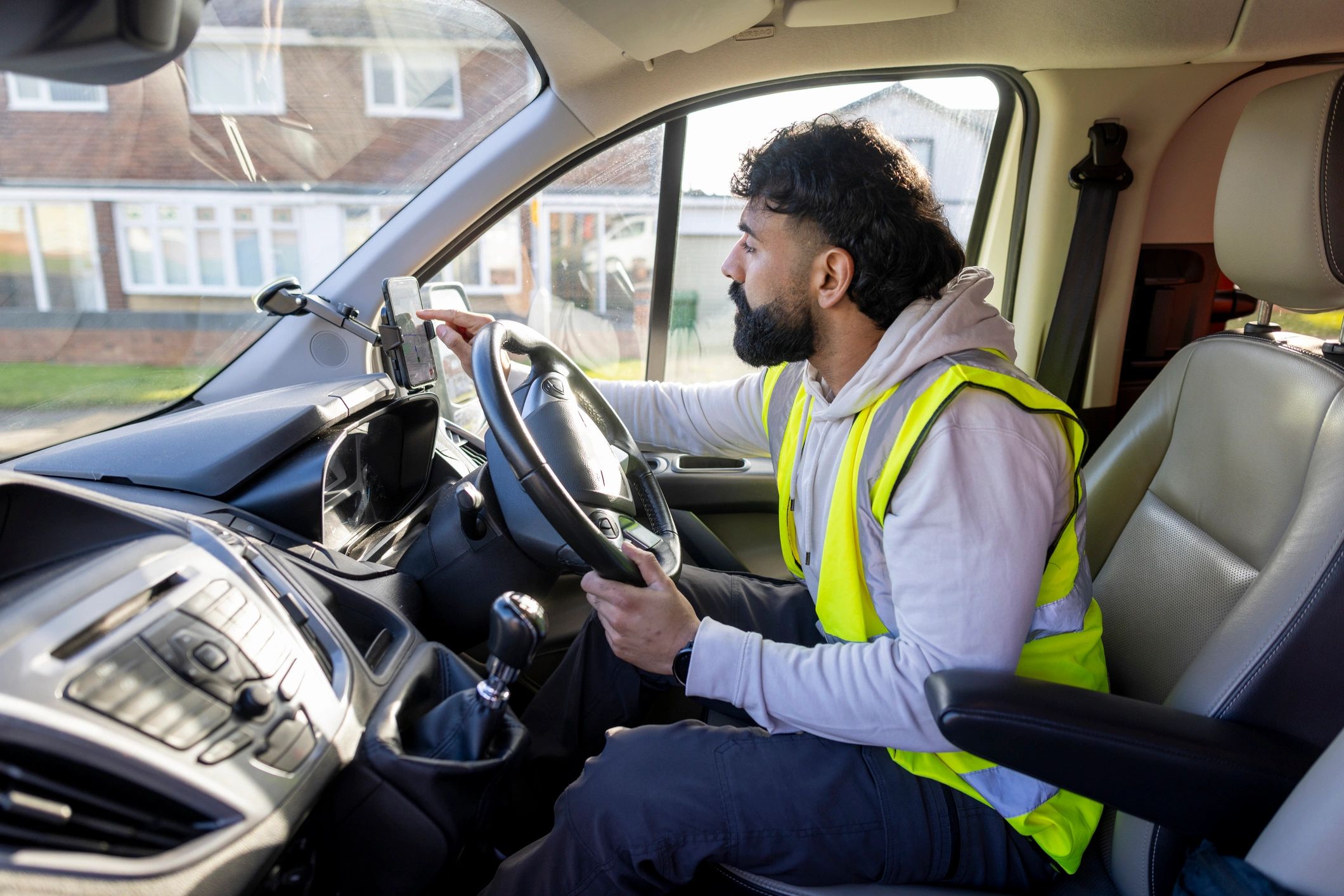Driver using a mobile app inside a vehicle