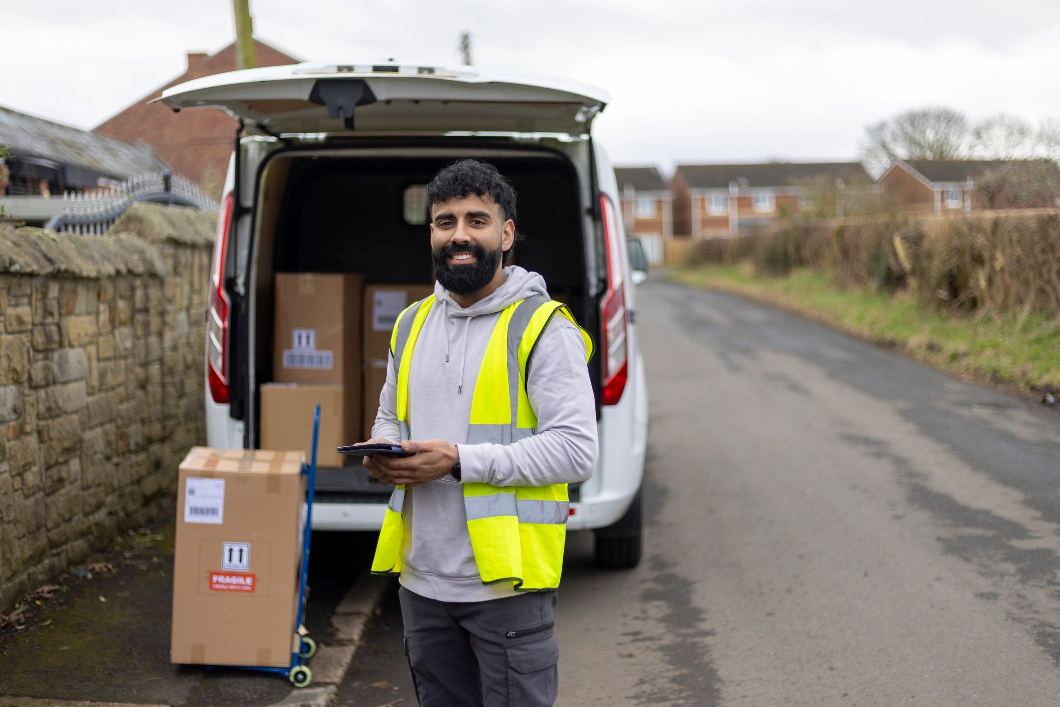 Delivery driver standing by vehicle