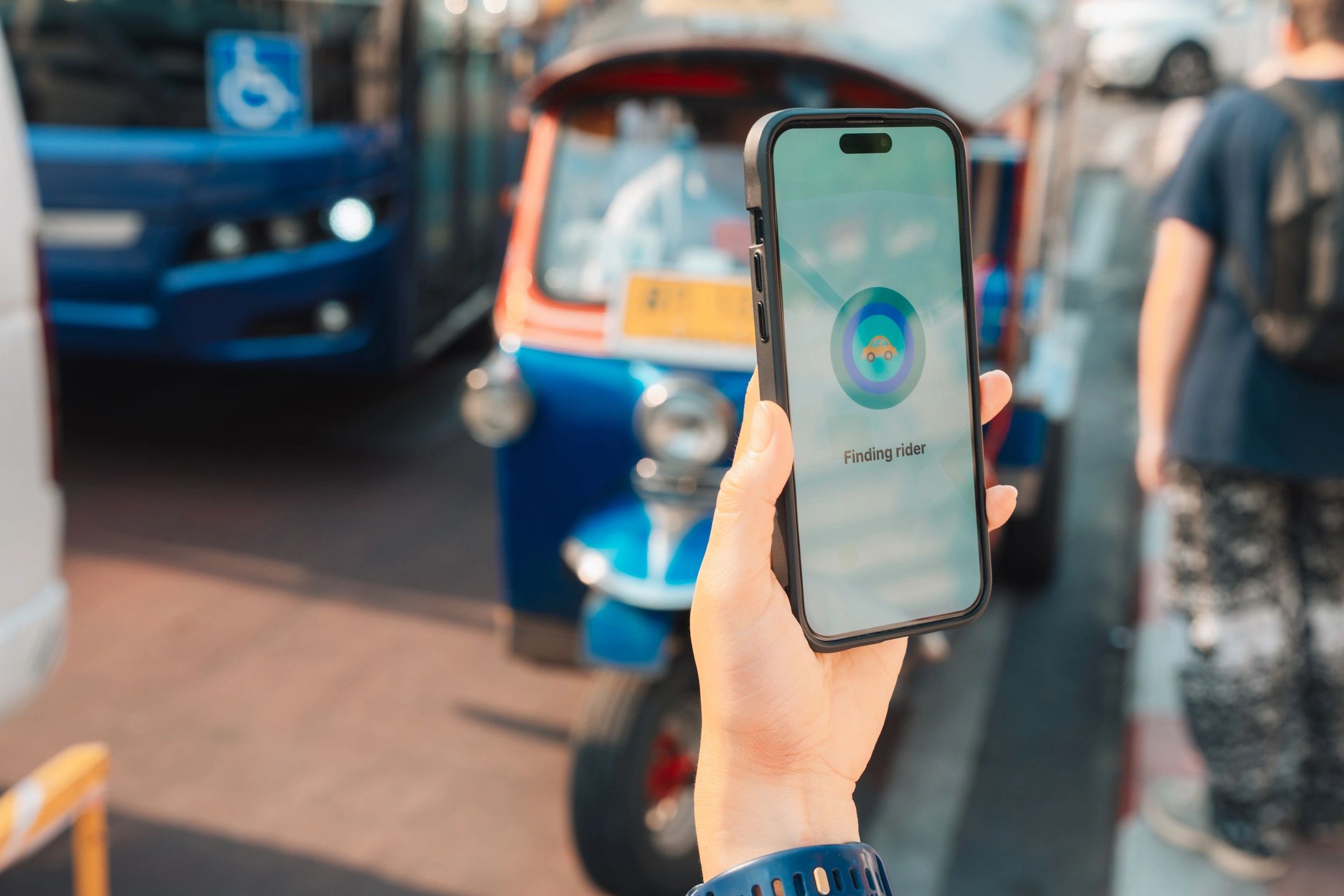 Woman using a smartphone to book a ride on a city street